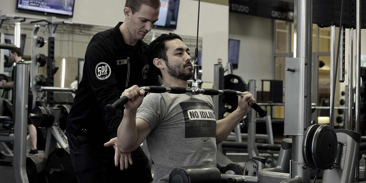 Personal trainer working with a client.