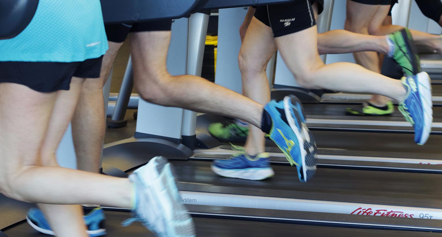 A group of people running on the treadmill