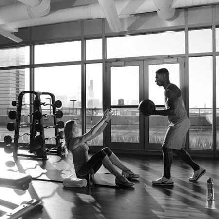 A couple working out together in the gym.