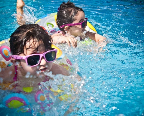 kids swimming in a outdoor pool