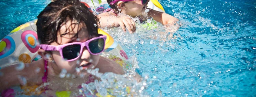 kids swimming in a outdoor pool