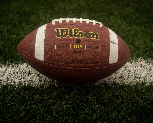 A Wilson football on a field