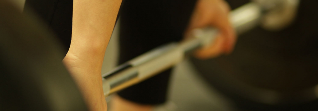 Woman weightlifting with heavy barbell