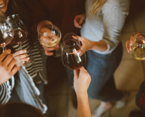 Friends cheering with wine glasses