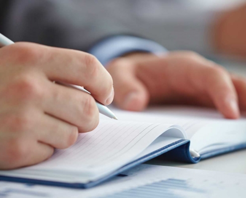 A man writing notes at a fitness workshop