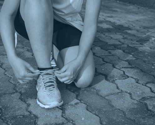 Runner tying shoelaces.