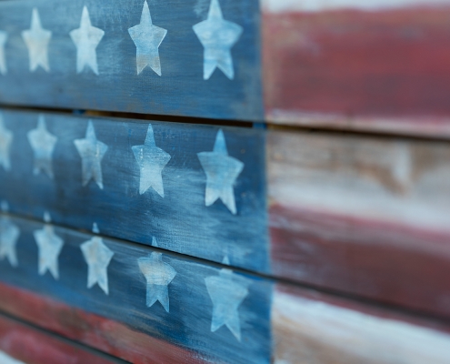 Texture of american flag painted over woodboard