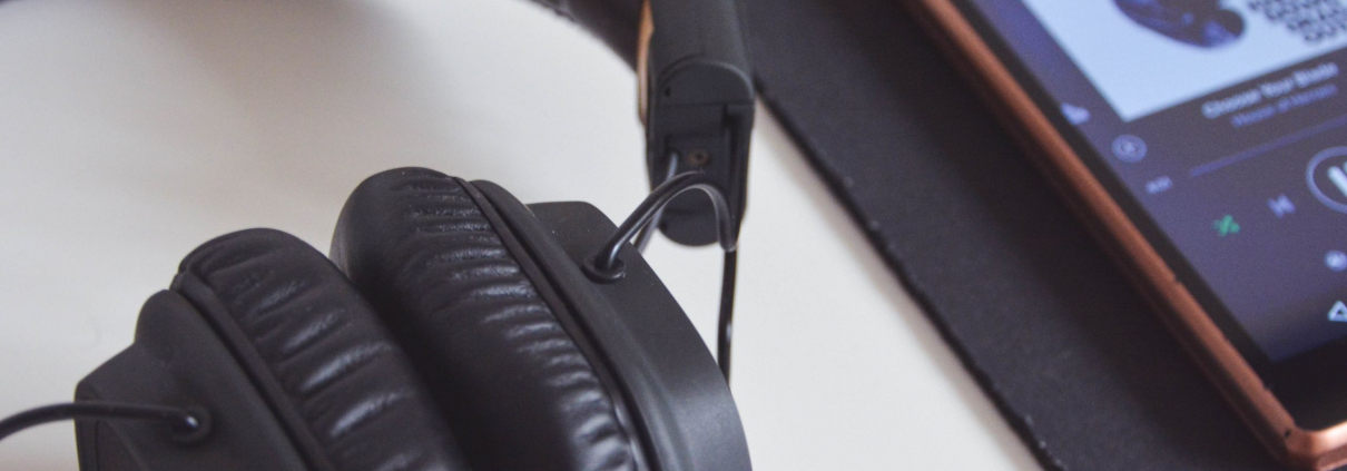 Headphones and iPhone playing a playlist