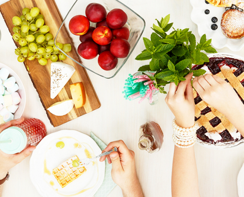 Friends eating around a table.
