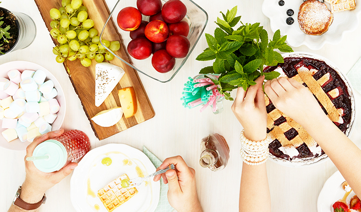 Friends eating around a table.