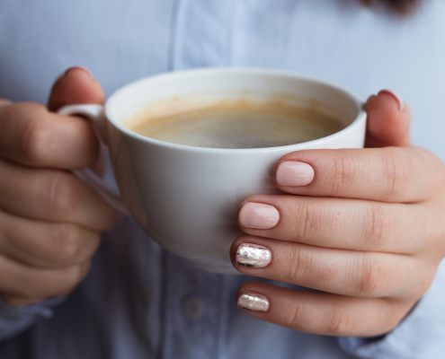 Woman's hands holding coffee mug