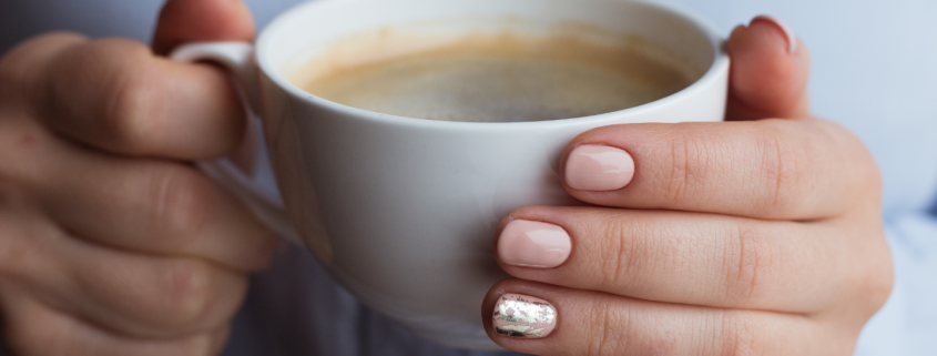 Woman's hands holding coffee mug