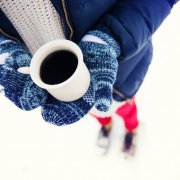 Girl in snow holding a coffee cup