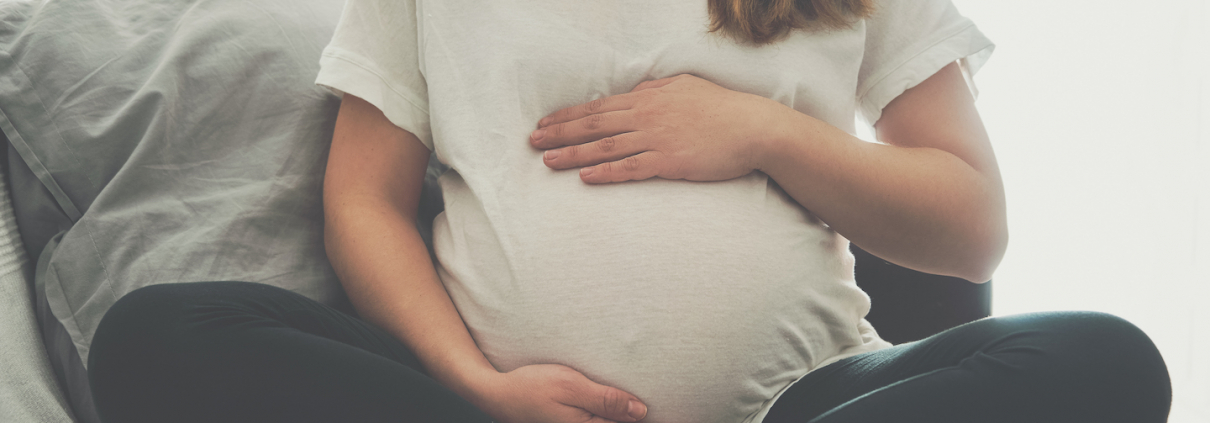 Pregnant woman touching her belly