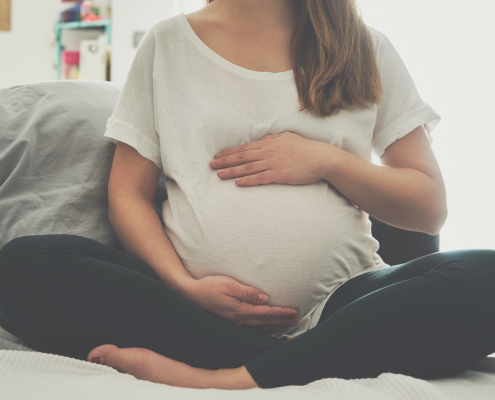 Pregnant woman touching her belly