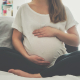 Pregnant woman touching her belly
