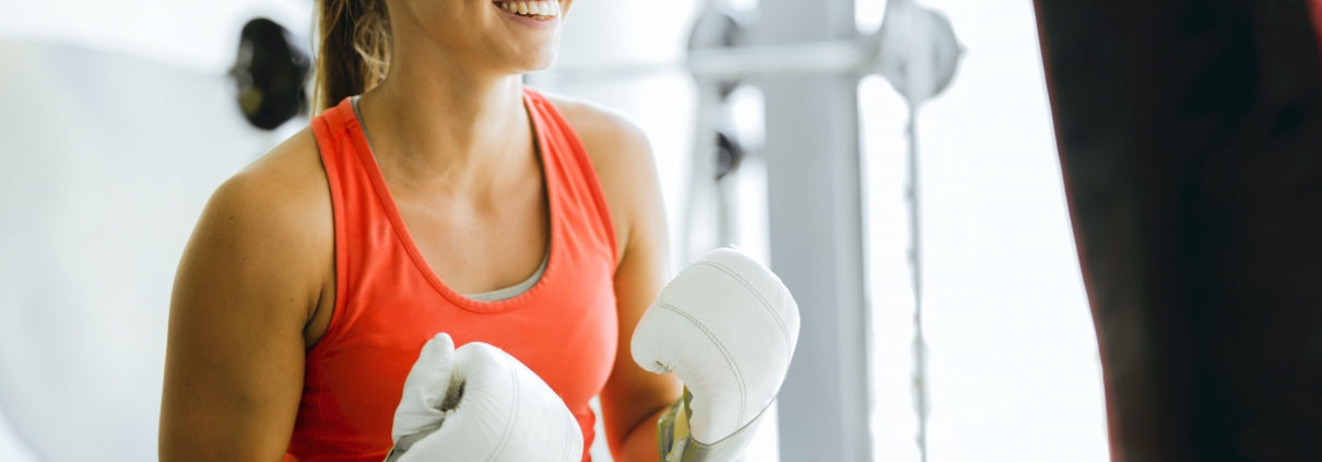 Young woman boxing and training in a gym