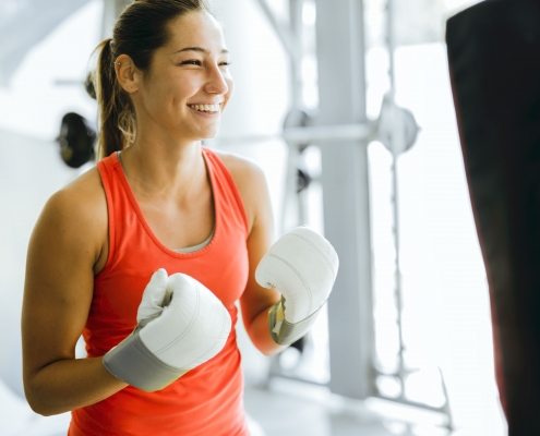 Young woman boxing and training in a gym