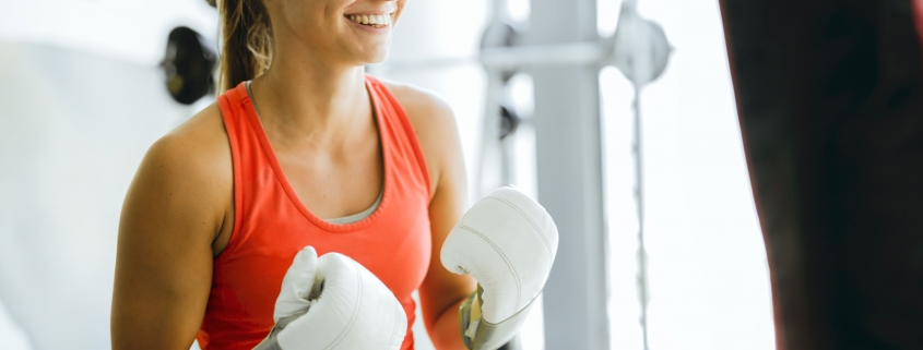 Young woman boxing and training in a gym