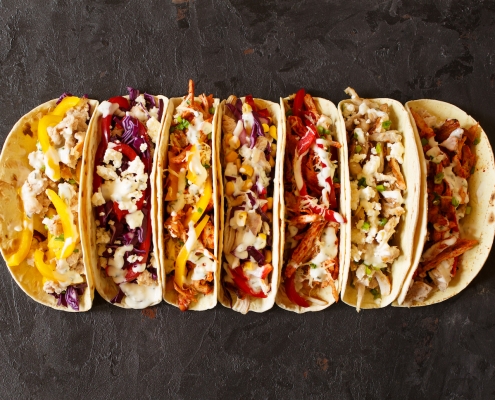 Varied traditional mexican corn tacos flat lay composition.