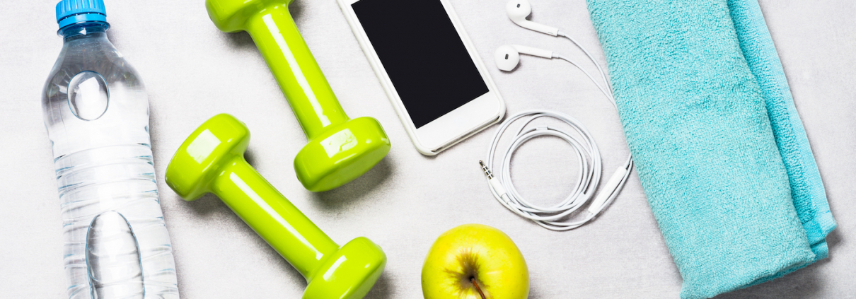 Dumbbells, measuring tape, water and smartphone top view. Fitness concept and healthy lifestyle.