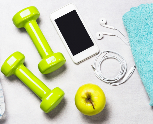 Dumbbells, measuring tape, water and smartphone top view. Fitness concept and healthy lifestyle.