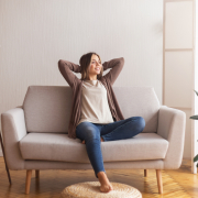 Millennial girl relaxing at home on couch, enjoying weekends, empty space