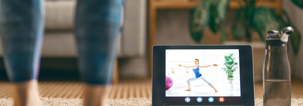 woman with ipad watching yoga class at home