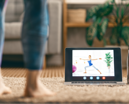 woman with ipad watching yoga class at home