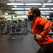 Woman using weight machine at gym