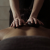 Client receiving a stone massage.