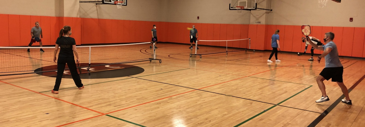 Image of a group of people playing pickleball