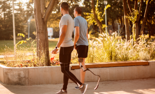 Two men walking outside in the sunshine