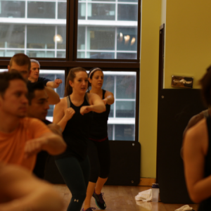 Men and women shadowboxing in a Shadowbox Shred group fitness class in Chicago