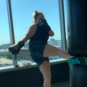 Woman kickboxing in a Contender group fitness class in Chicago