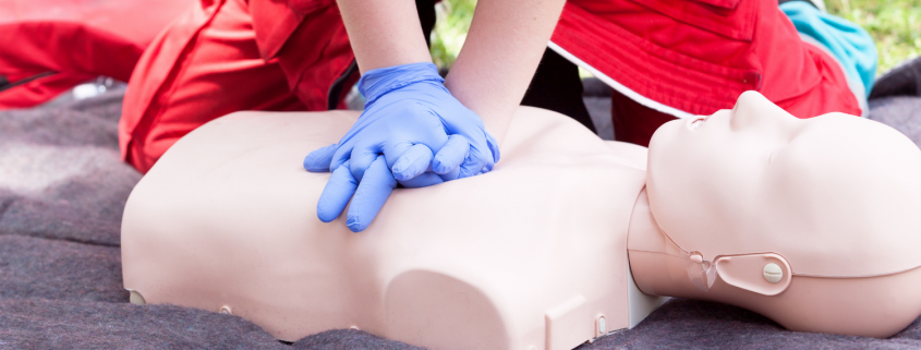Person performing CPR on a dummy