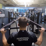 FFC Personal Trainer using lat pulldown weight machine at the gym