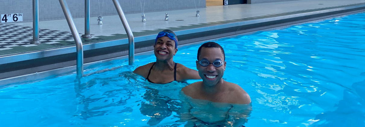 Juan and trainer Joy smiling in the pool