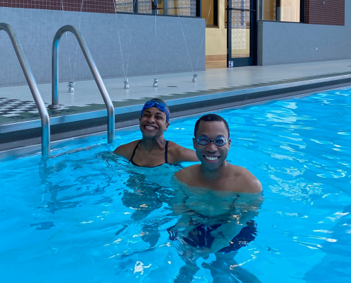 Juan and trainer Joy smiling in the pool