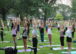 People in mountain pose in an outdoor yoga class