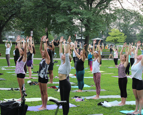 People in mountain pose in an outdoor yoga class