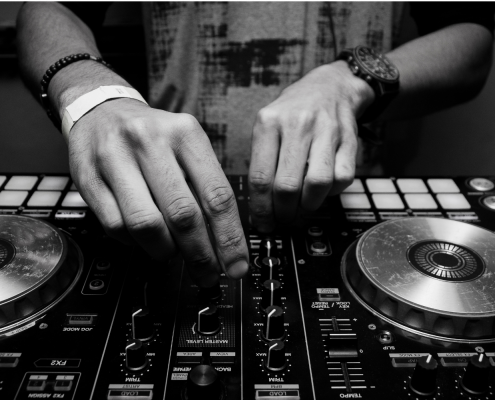 A pair of hand using DJ equipment