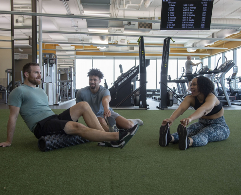 3 Friends Stretching On The Turf