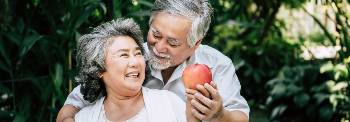 Older couple sitting outside on a bench