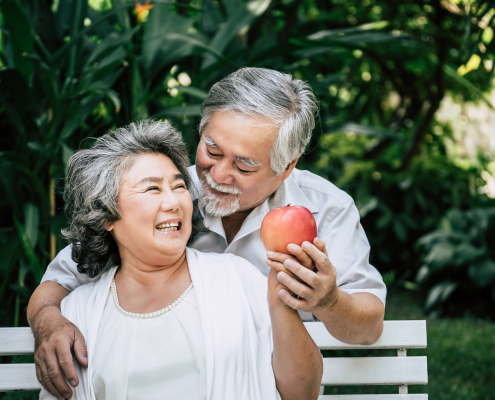 Older couple sitting outside on a bench