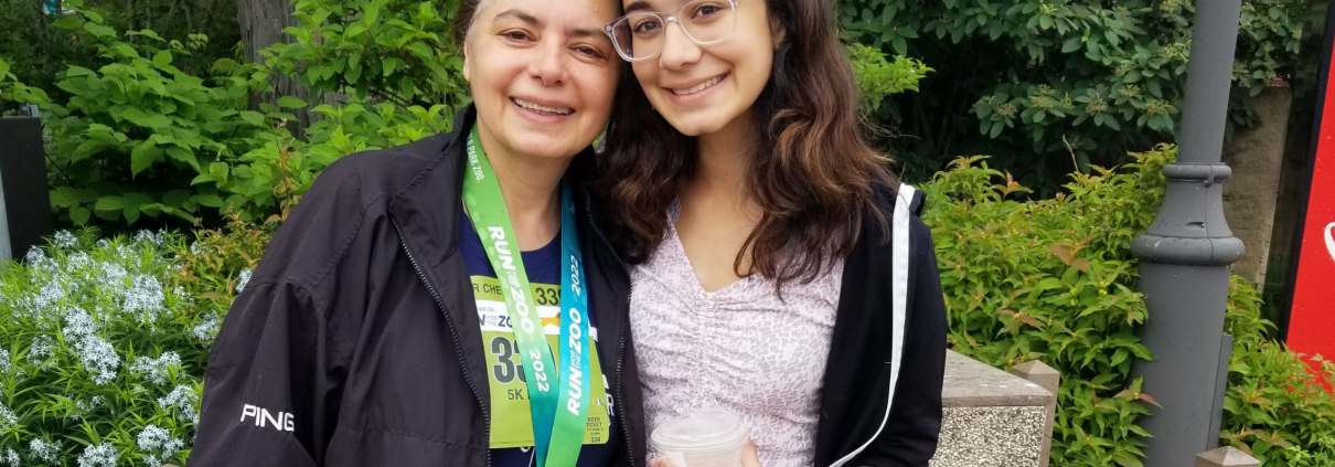 FFC Member Renu Kulkarni standing outside with her daughter.