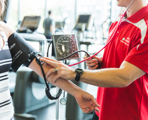 man checking women's heart rate