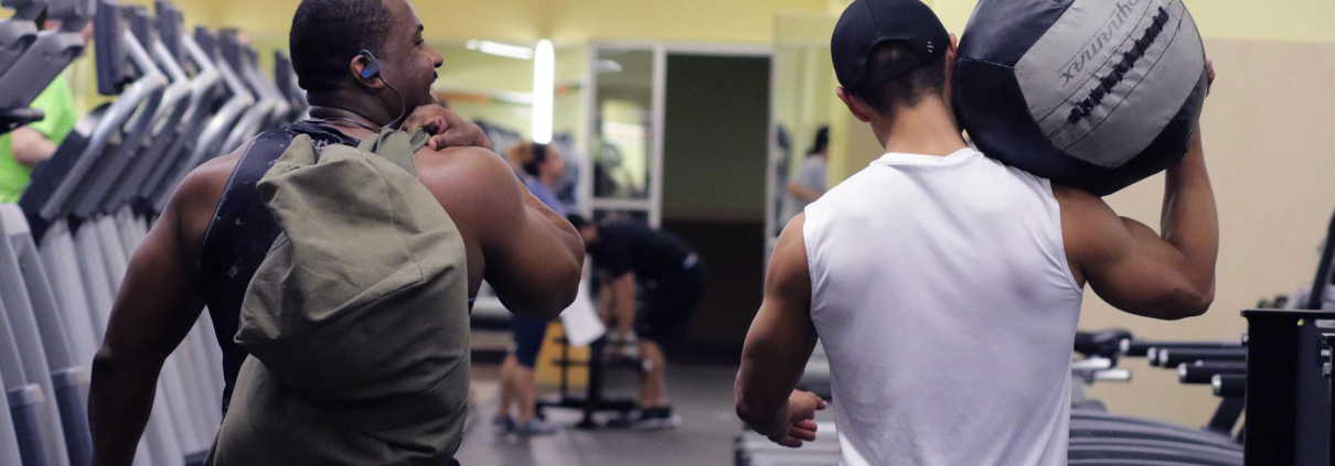 Friends walking together at a gym.