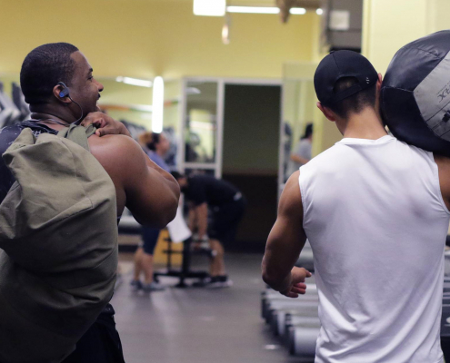 Friends walking together at a gym.