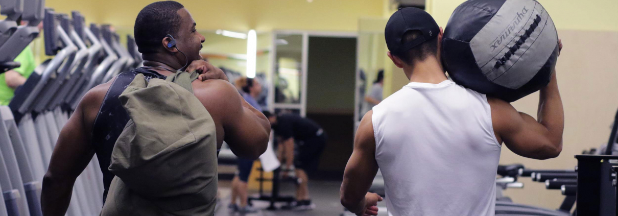 Friends walking together at a gym.